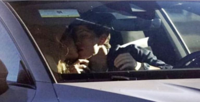Zendaya and Tom Holland kissing in his car.